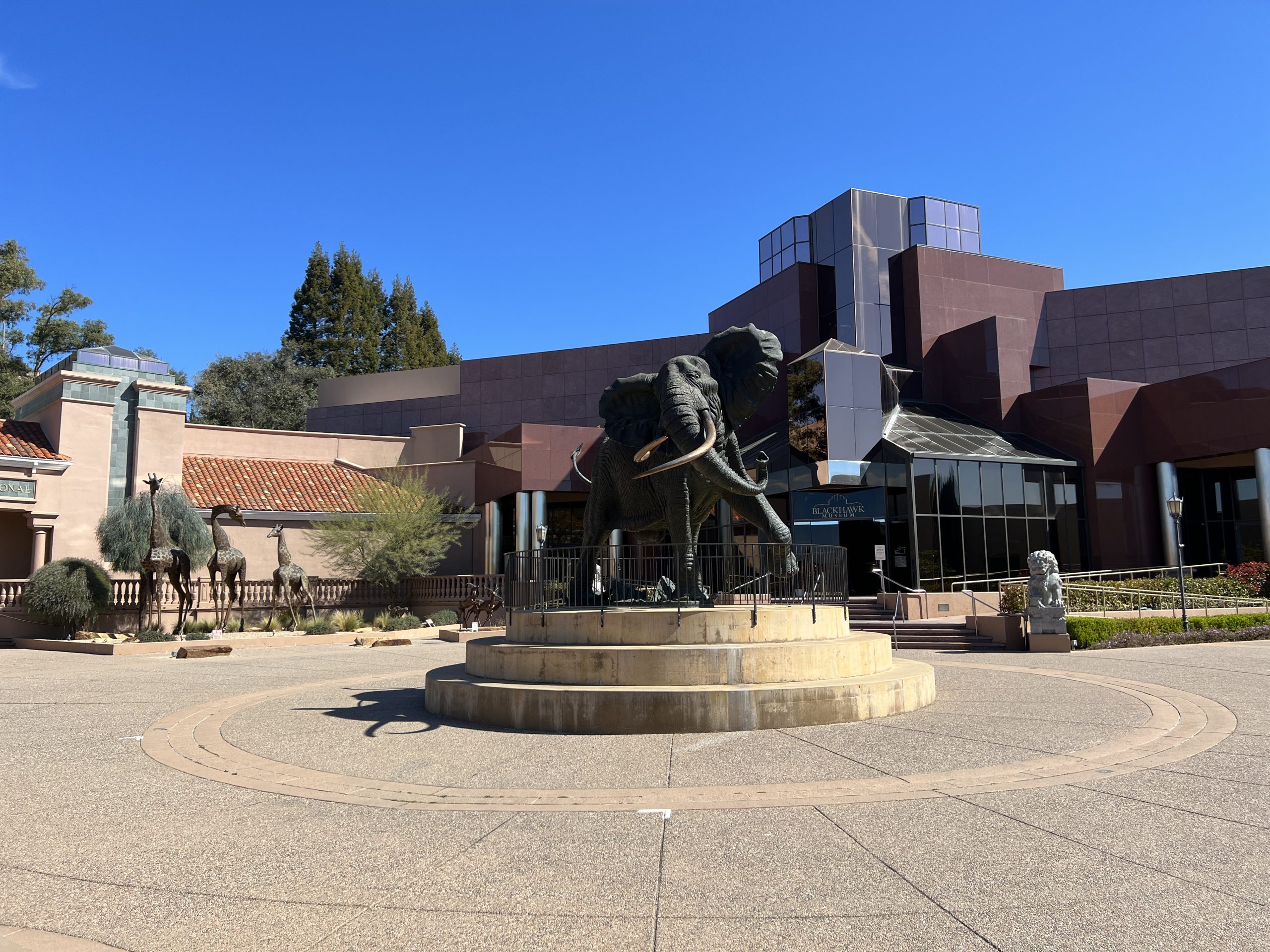 A statue of an elephant in front of a building.