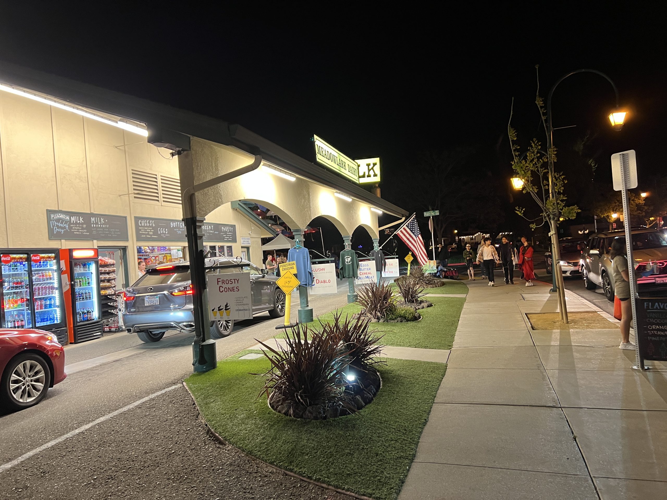 A street with grass and lights on the side of it