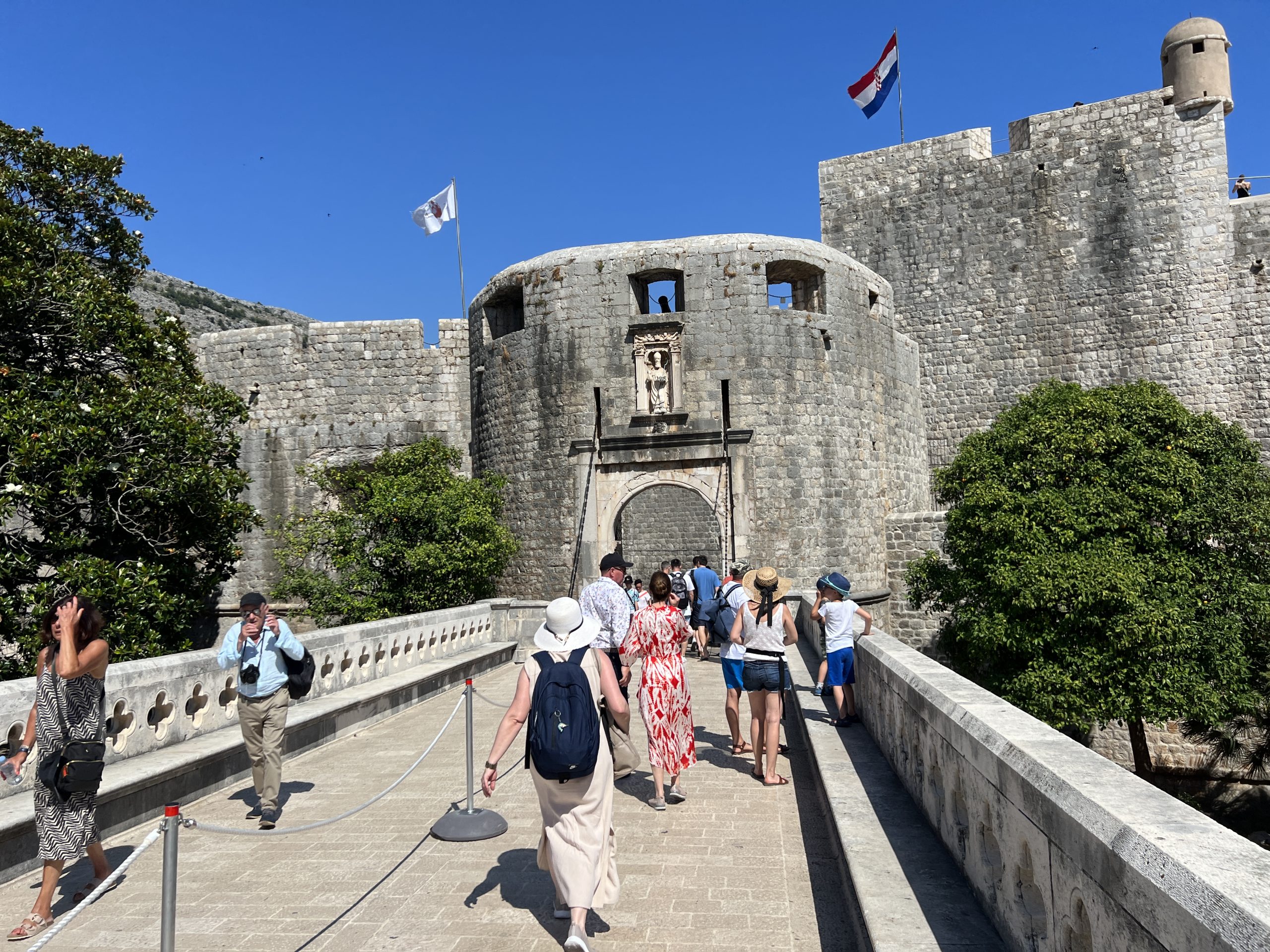 A group of people walking on the bridge.