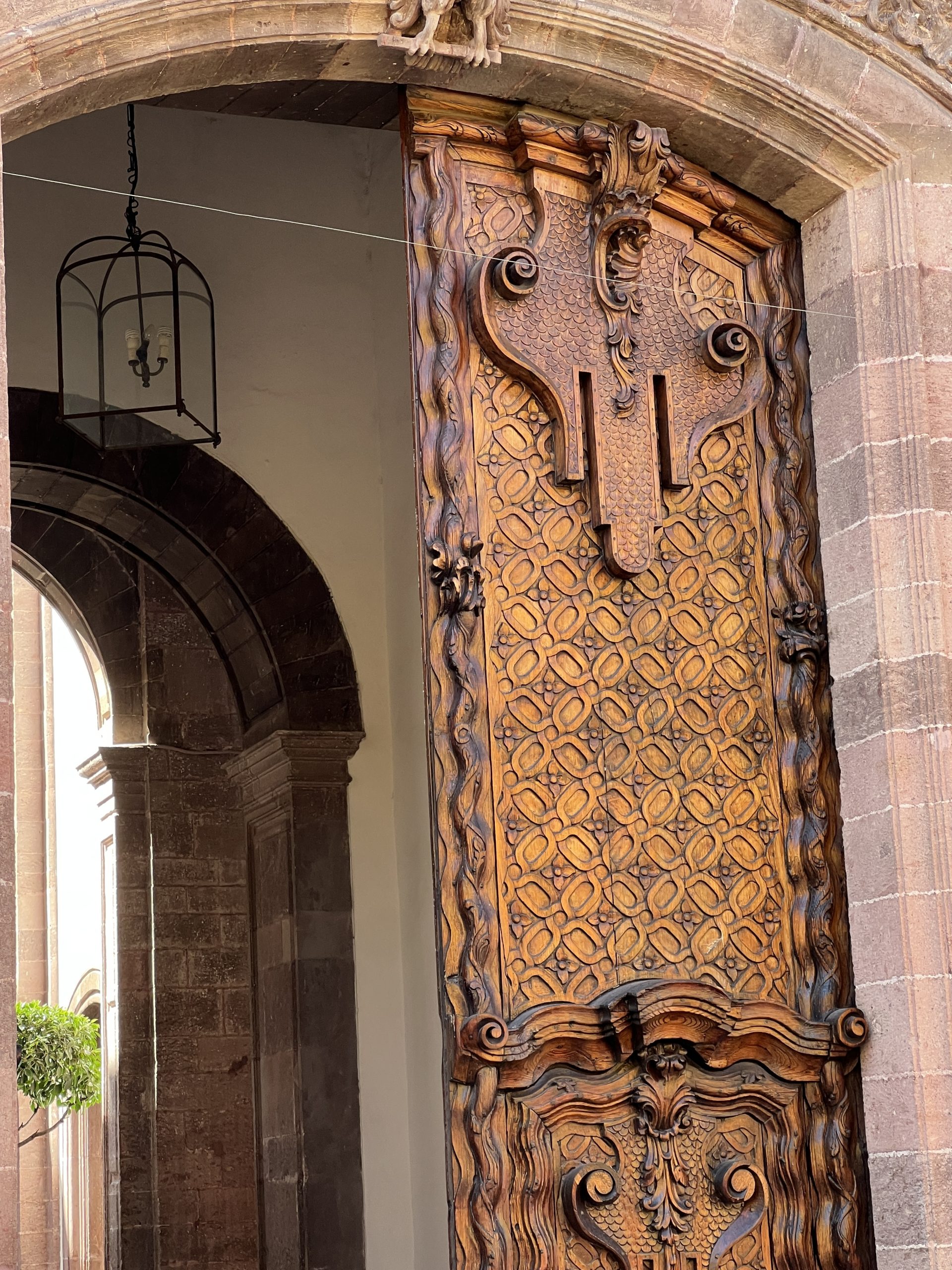 A wooden door with intricate carvings on it.