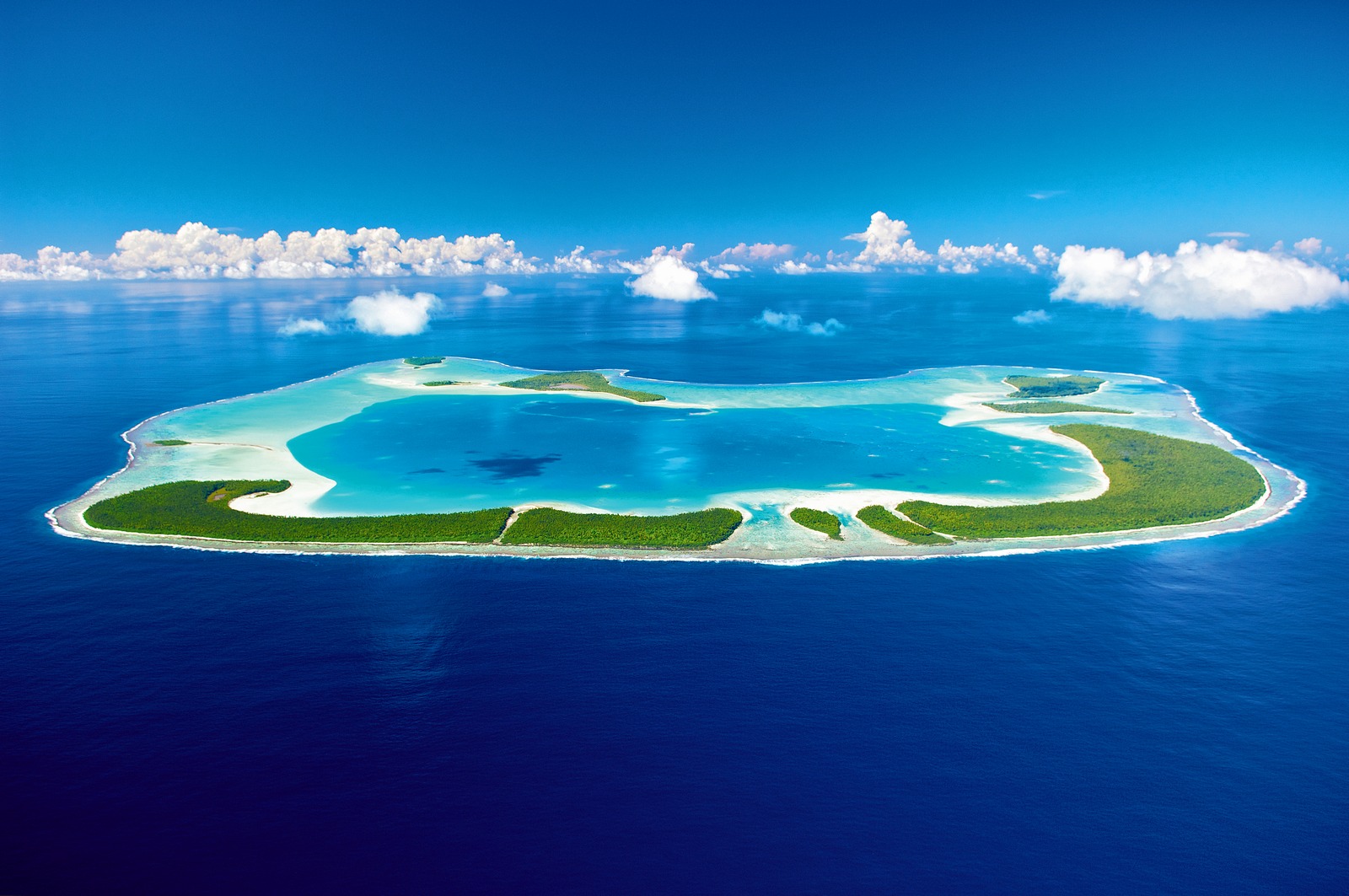 A large body of water with some clouds in the sky