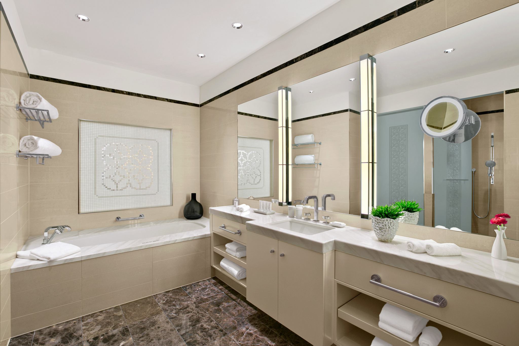 A bathroom with two sinks and a large mirror.