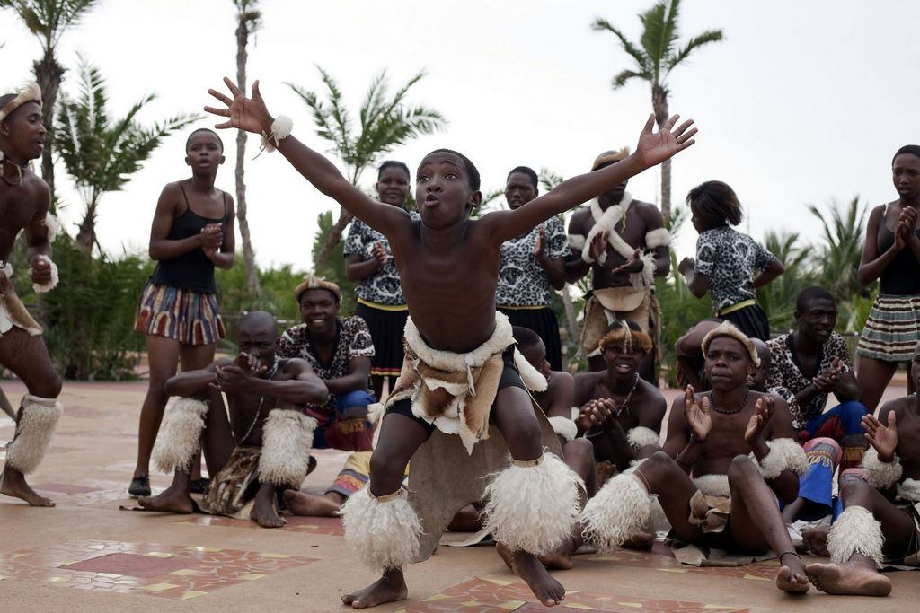 A man in traditional african clothing and people