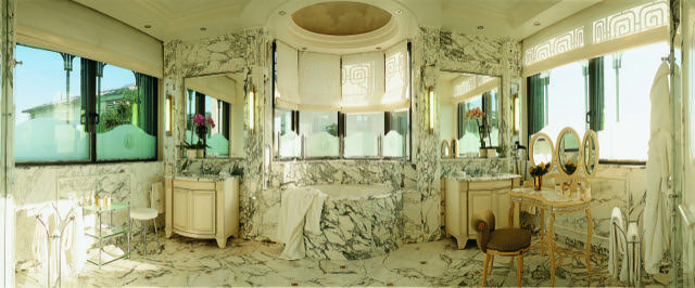 A bathroom with marble walls and floors.