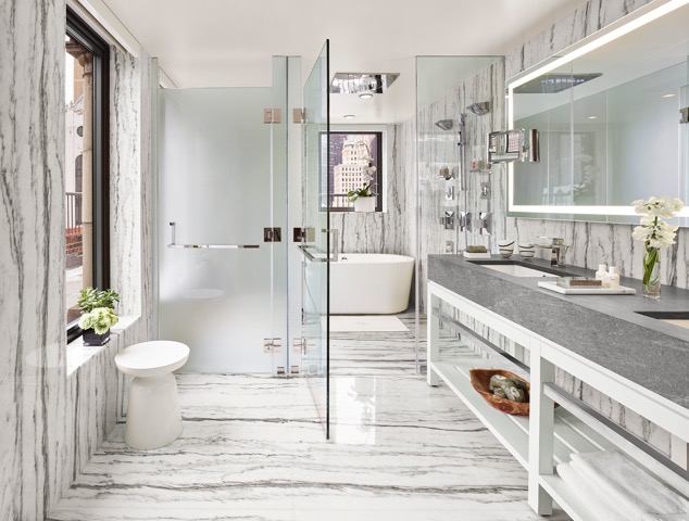 A bathroom with marble floors and walls.