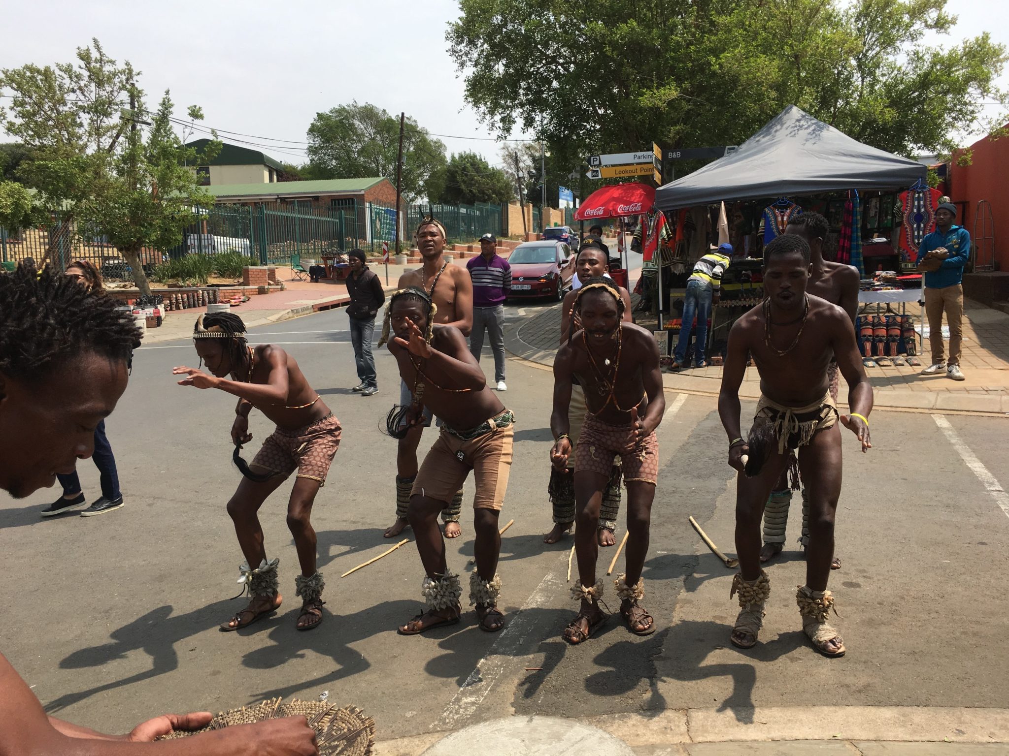 A group of people standing on the side walk