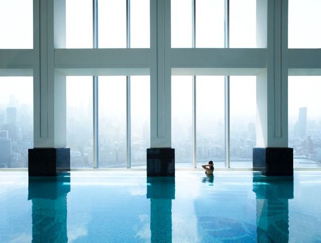 A person in the middle of an indoor pool.