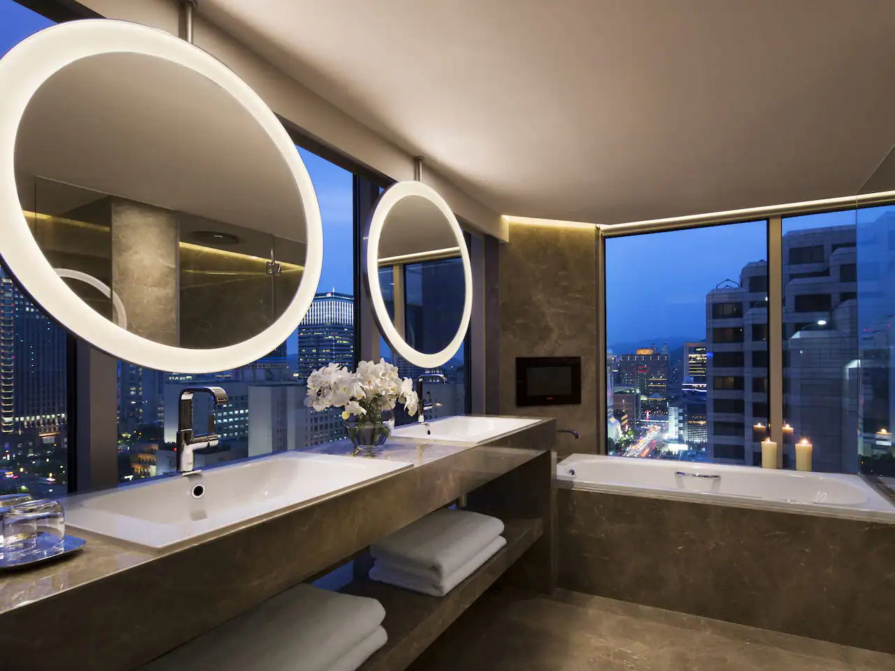 A bathroom with two sinks and a tub