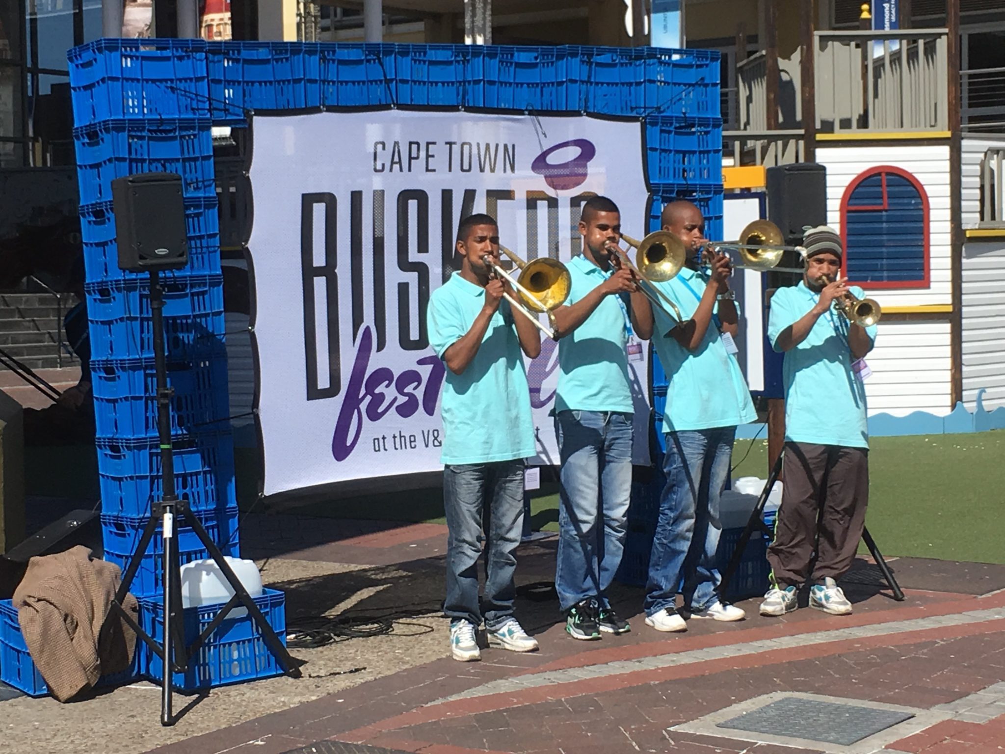 A group of young men playing brass instruments.