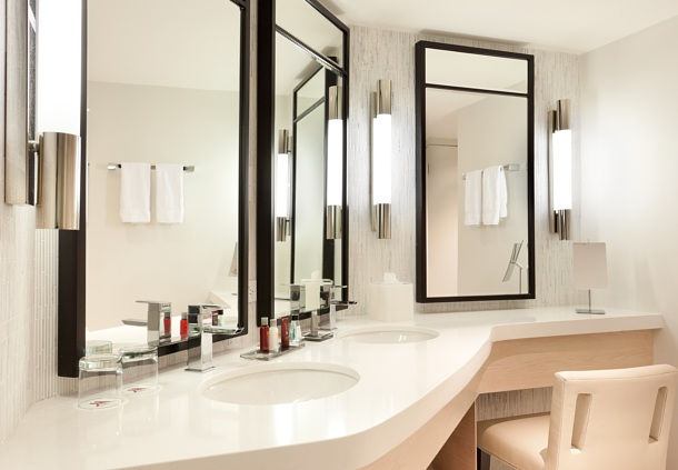 A bathroom with two sinks and mirrors in it