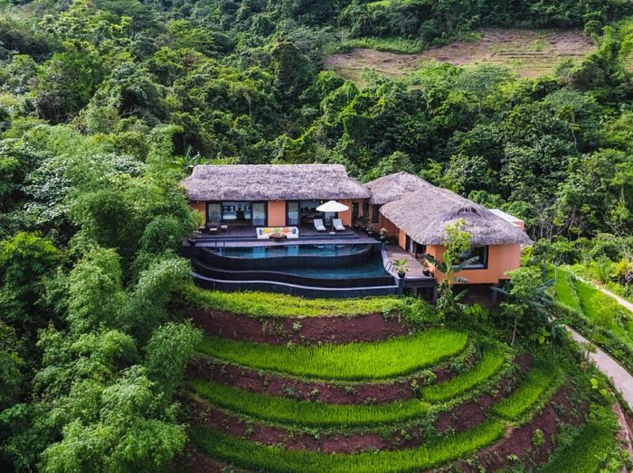 A house with a pool on top of a hill