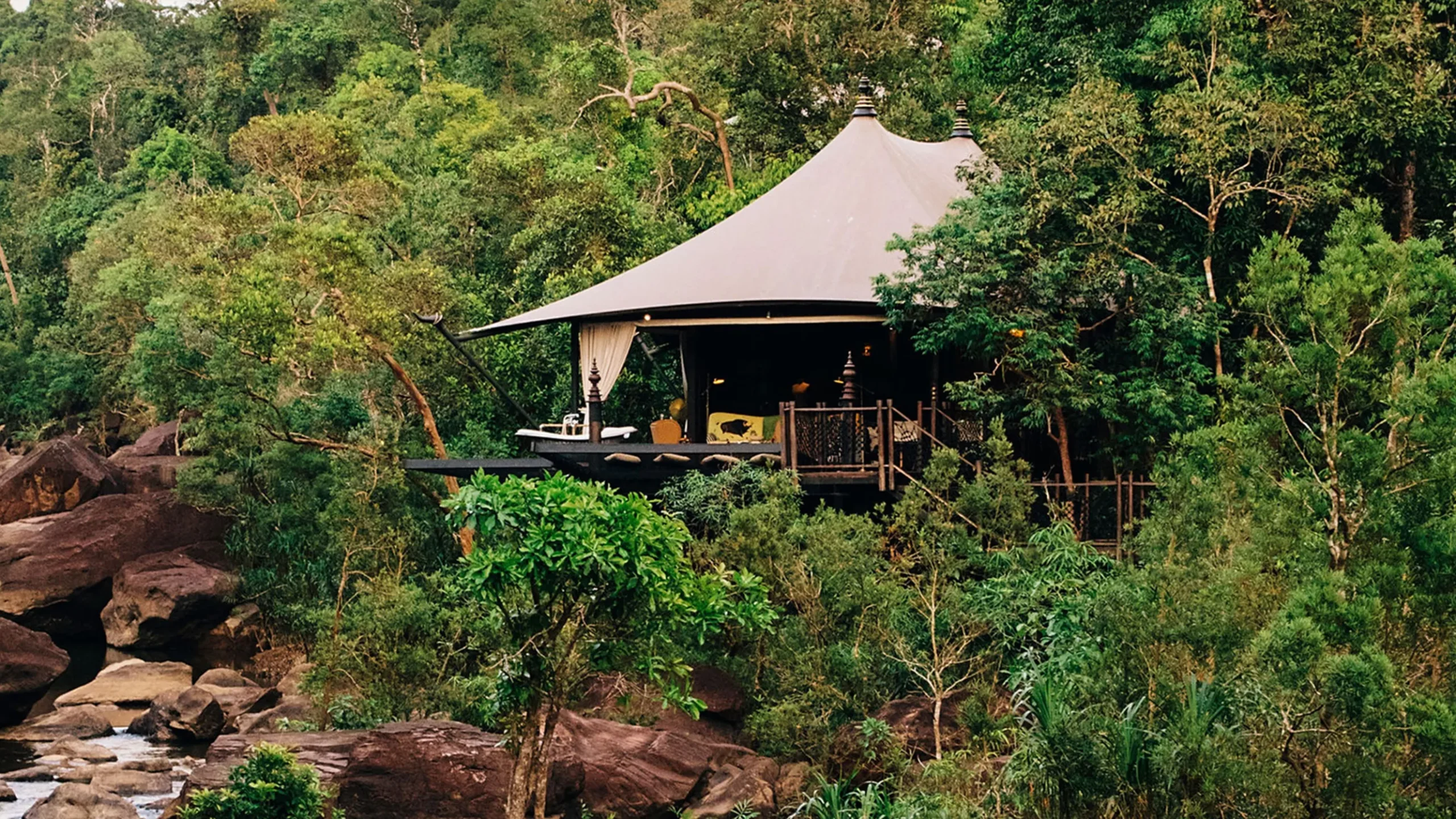 A tent in the middle of a forest.