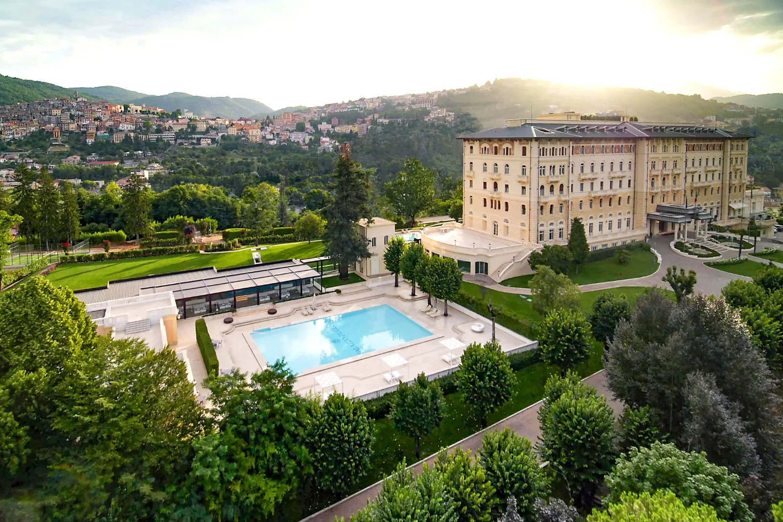 A large hotel with a pool and a building