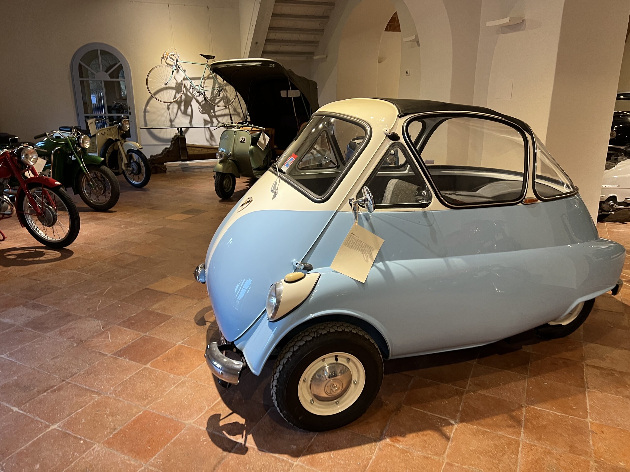 A blue and white car parked in a room.