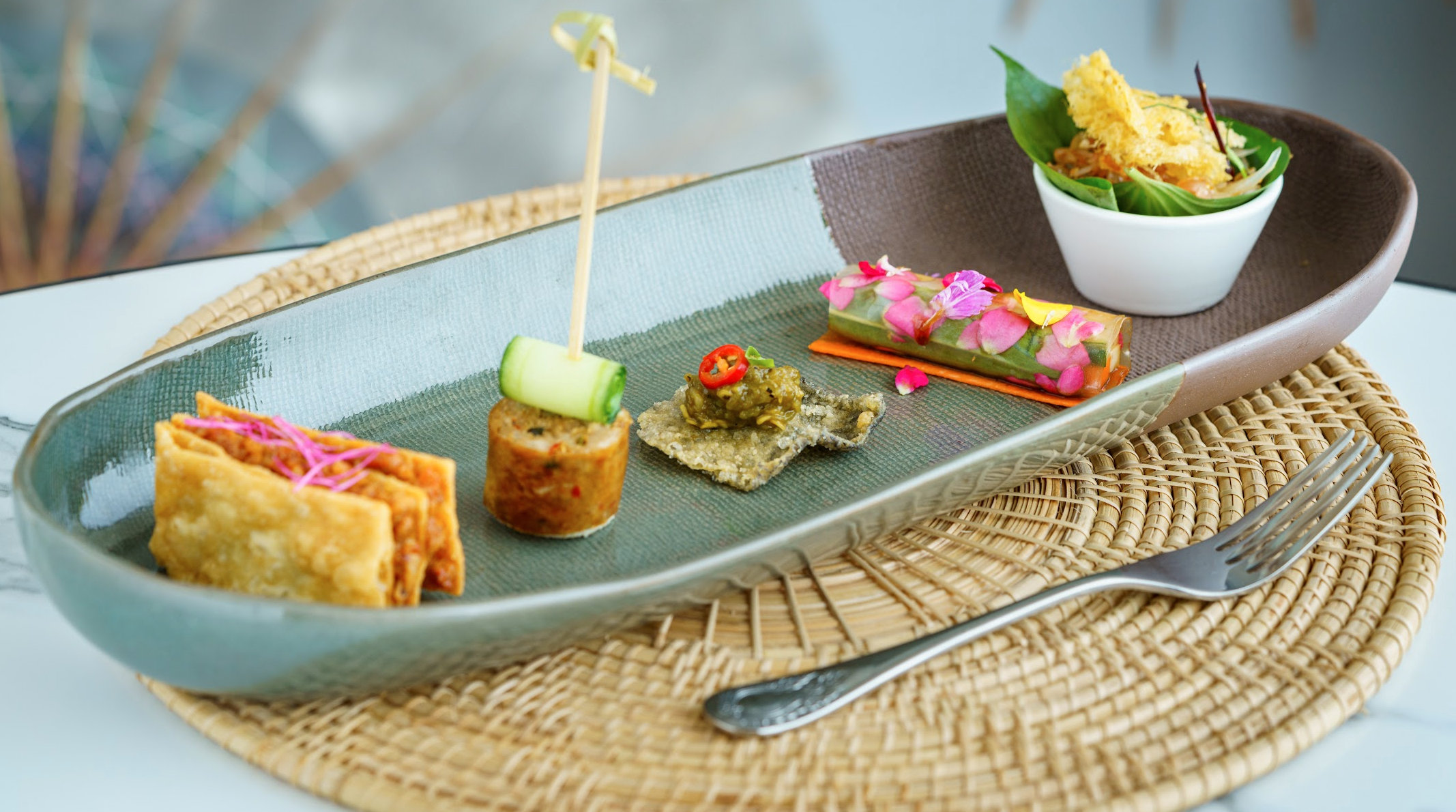 A plate of food on a table with a spoon.