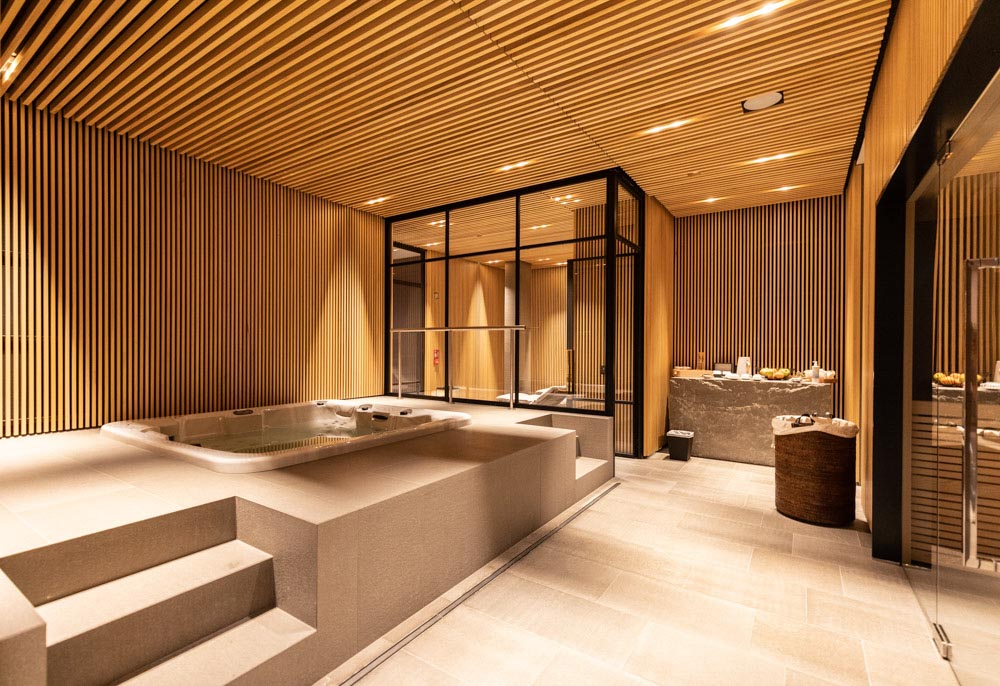 A large spa room with a wooden ceiling and walls.