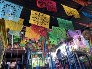 A colorful ceiling with many hanging decorations.