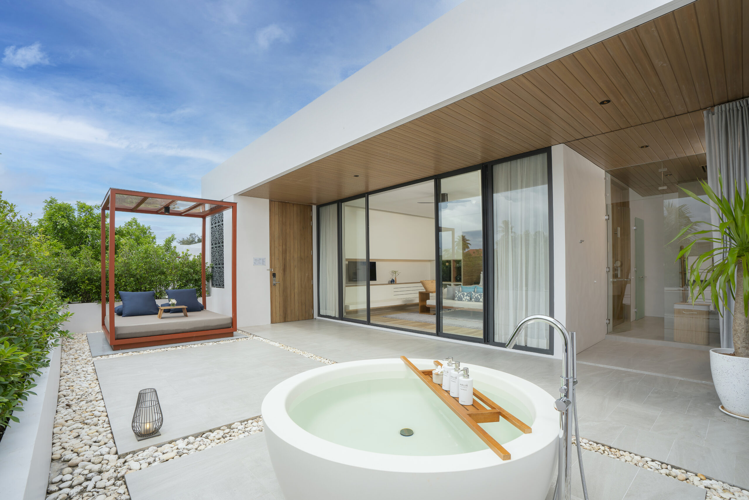 A large outdoor tub sitting in the middle of a patio.