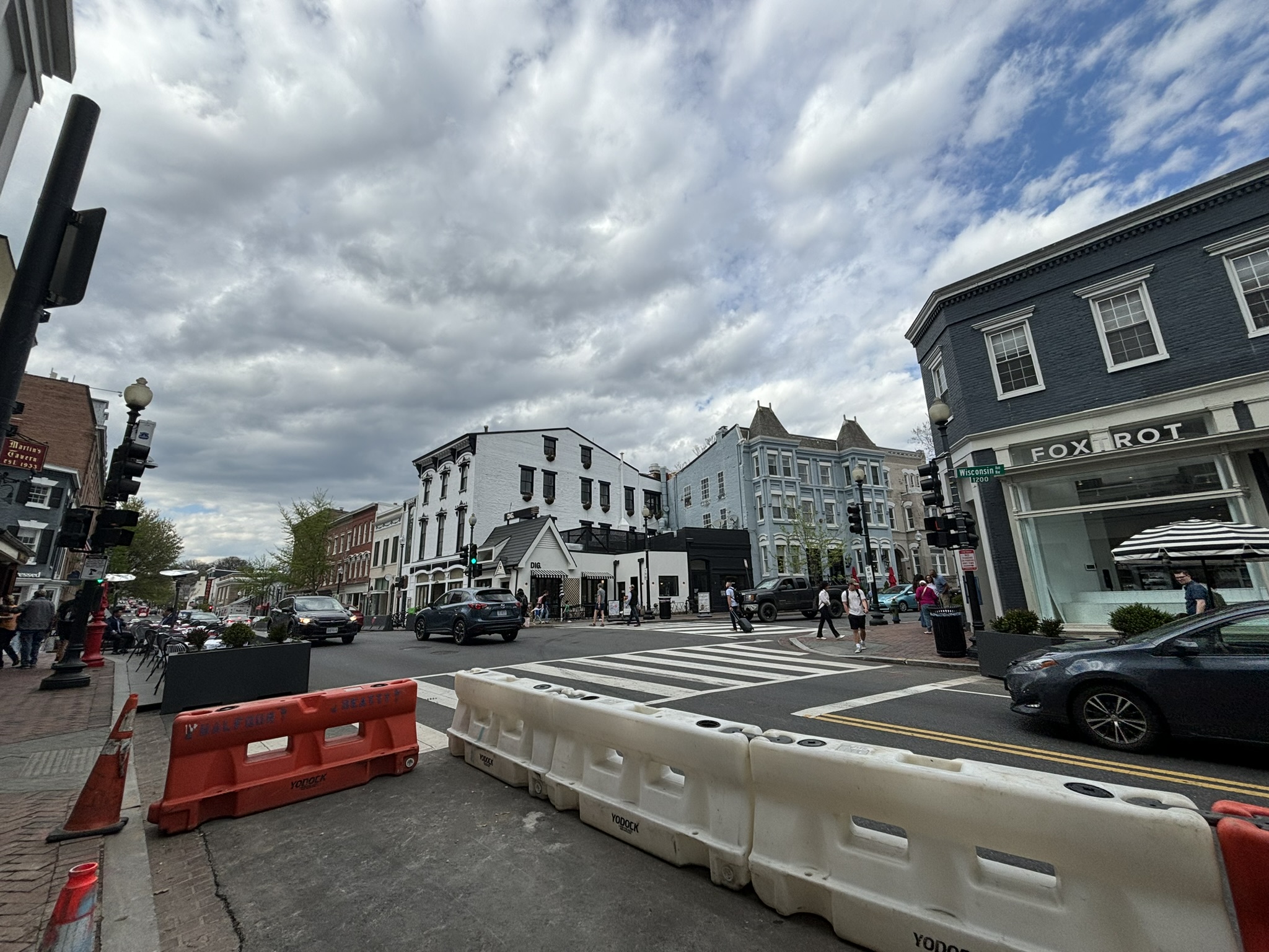 A street with cars parked on the side of it.