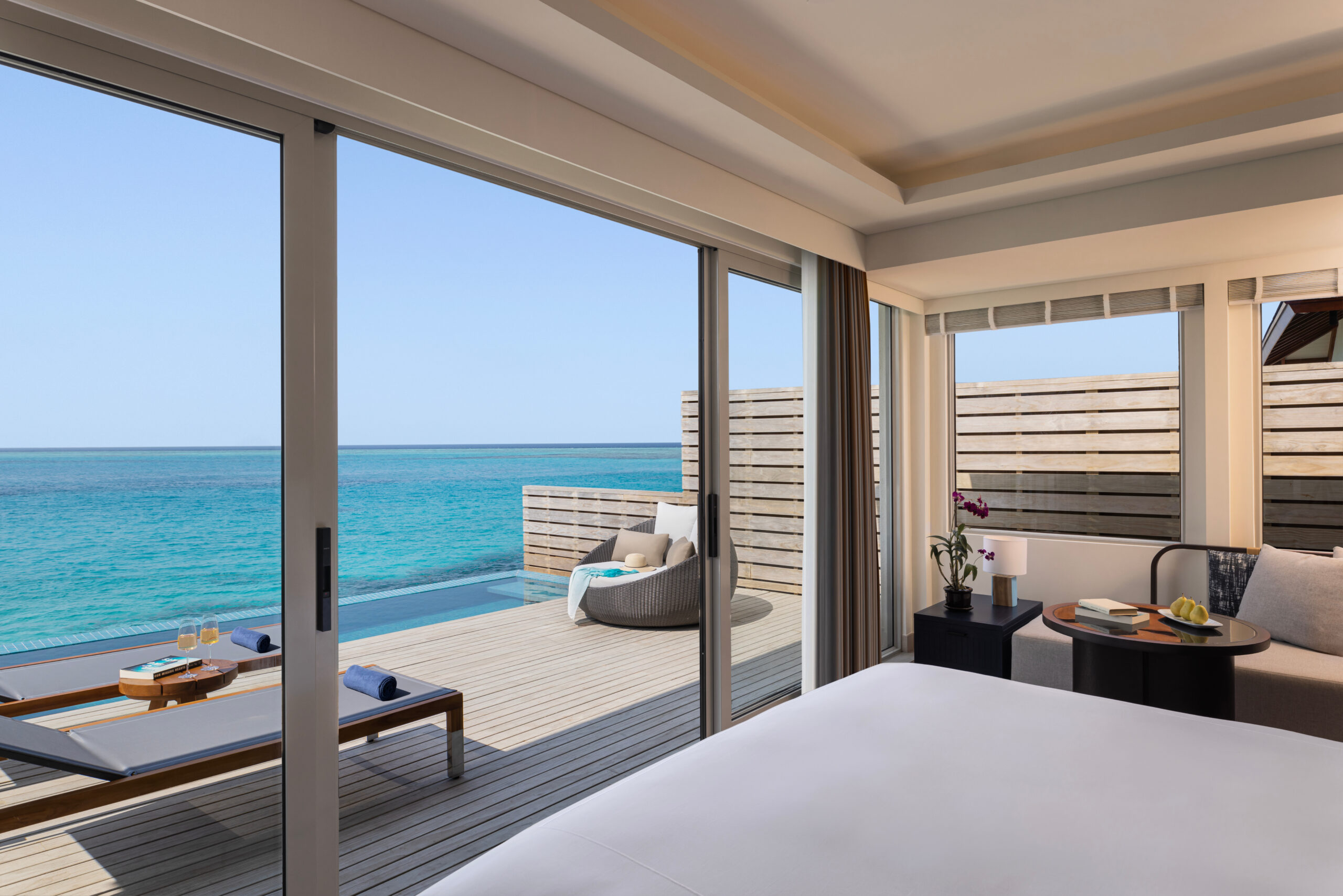 A bedroom with an ocean view and a bed