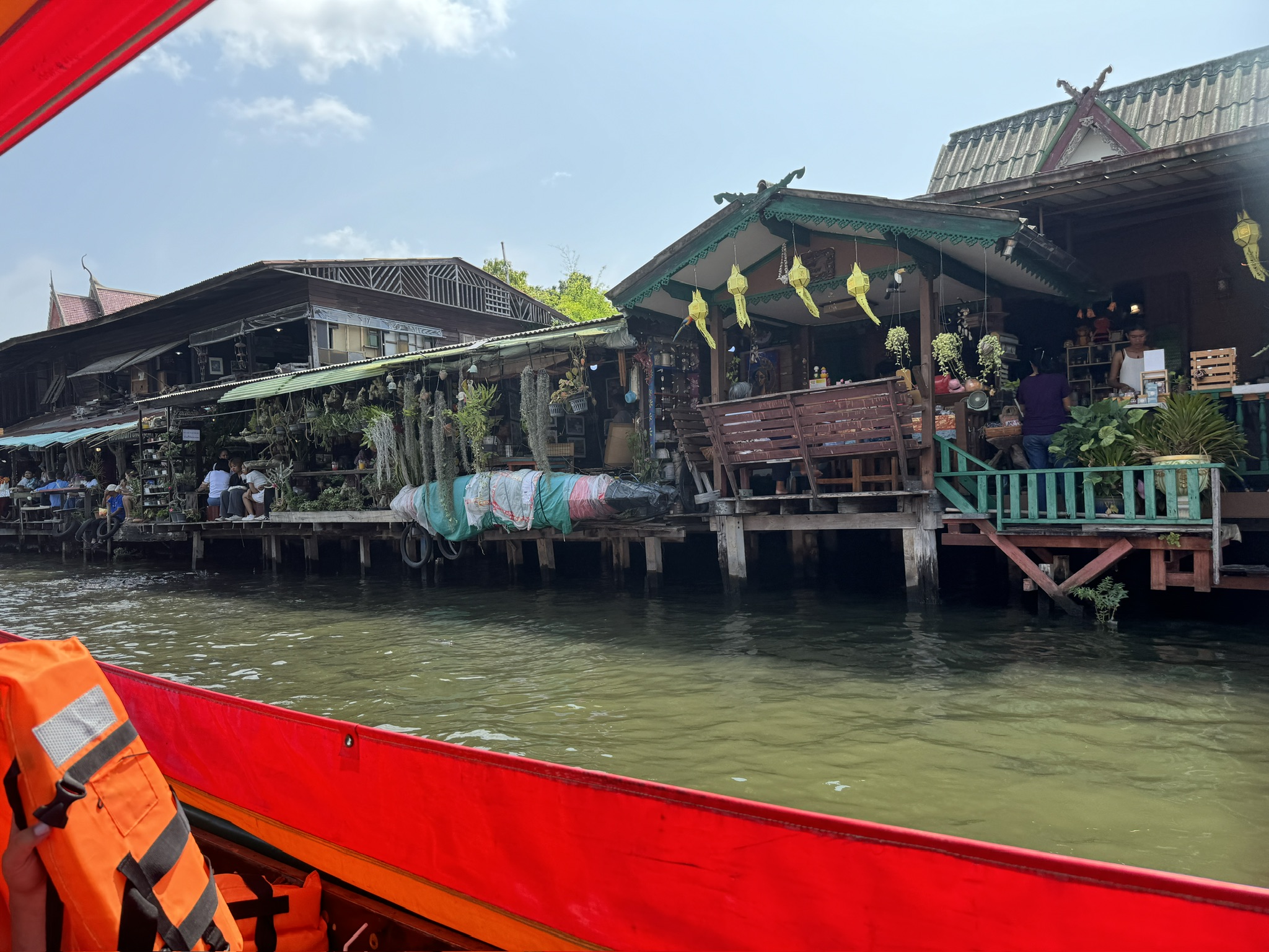 A boat with people sitting on it in the water.