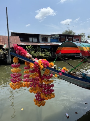 A boat with balloons floating on it in the water.