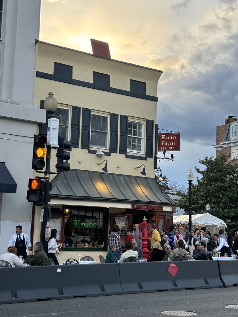 A crowd of people standing around a building.