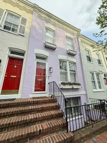 A row of houses with steps leading to them.